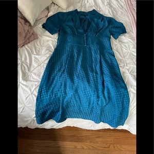 In excellent condition.  Beautiful teal A line dress